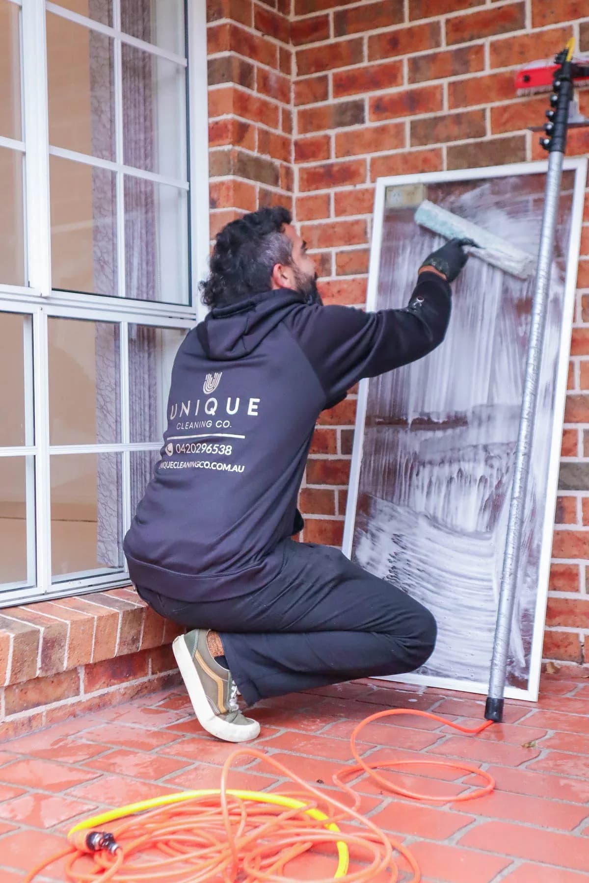 Cleaning a fly screen with a dedicated brush