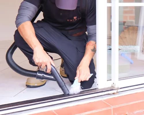 A fly screen being brushed clean